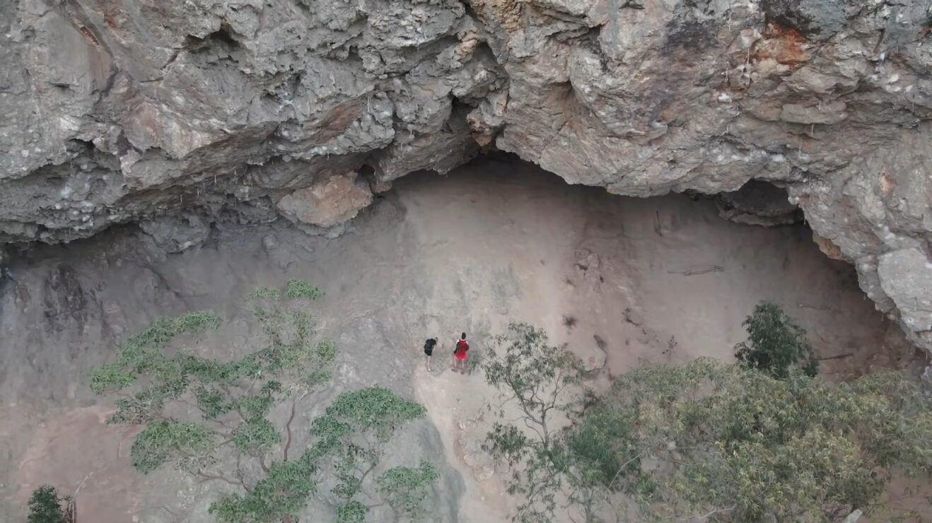 Aerial shot of a cliff face and two figures