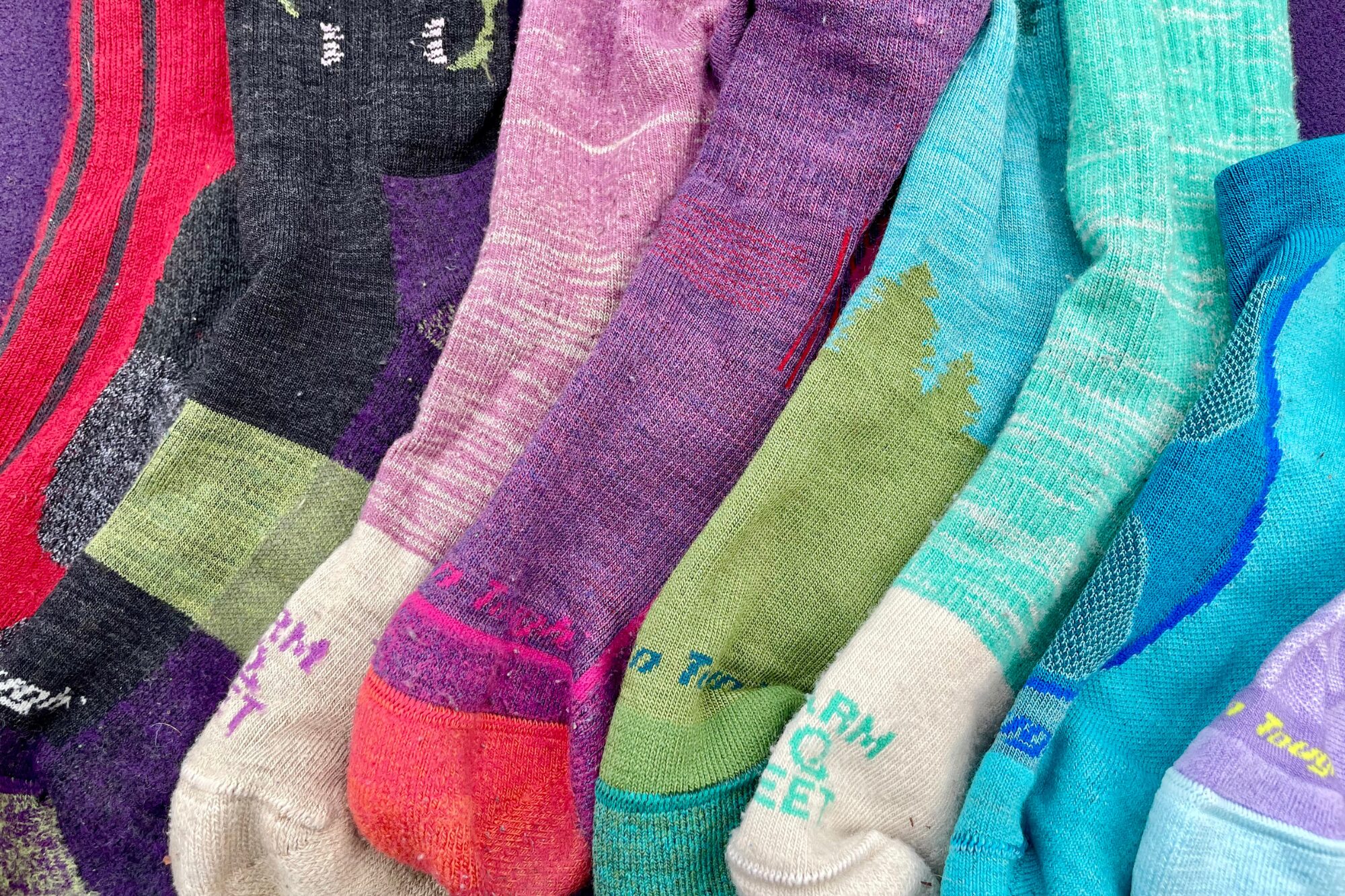 A brigh, colorful pile of different socks that we tested.