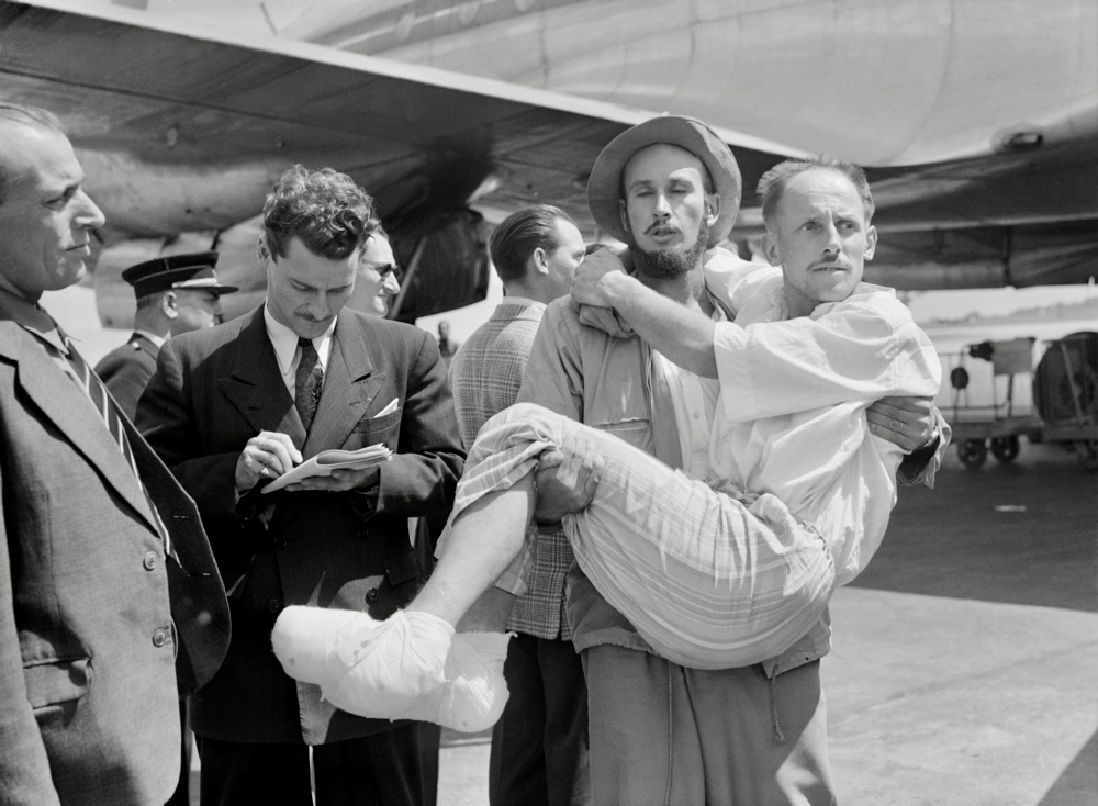 Lionel Terray carries Louis Lachenal, at the Orly Airport in France.